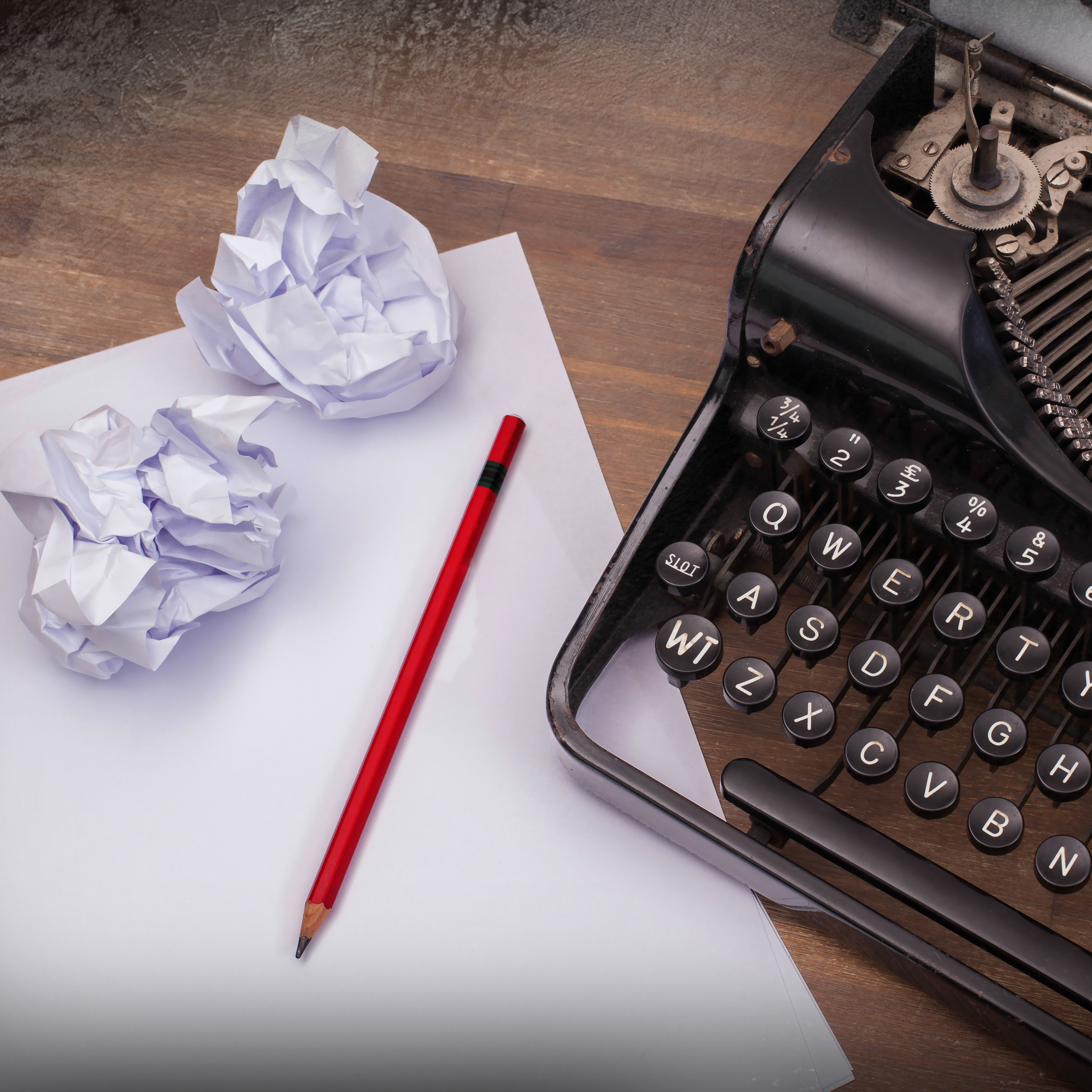 typewriter, paper and pencil